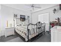 Bright bedroom featuring an ornate iron bed frame, ceiling fan, and a window with blinds at 4616 Greenbriar Dr. # H-4, Little River, SC 29566