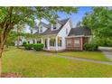 Elegant two-story house with white columns, brick accents, and a well-manicured lawn at 4721 National Dr., Myrtle Beach, SC 29579