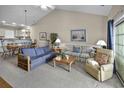 Well-lit living room with vaulted ceiling, neutral paint, carpeting and a dining area in the background at 4878 Luster Leaf Circle # 402, Myrtle Beach, SC 29577