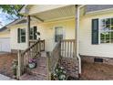 Inviting front porch with flower pots and brick steps at 505 Forestbrook Dr., Myrtle Beach, SC 29579