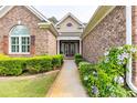 Inviting home entrance framed by lush landscaping and a brick facade at 512 Allspice Ln., Myrtle Beach, SC 29579