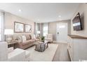 Relaxing living room with a plush sofa, modern entertainment center, and inviting atmosphere at 532 Ryegrass Way # 0029B, Murrells Inlet, SC 29576