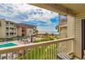 Balcony view overlooking pool, lawn area, buildings, and ocean at 5601 N Ocean Blvd. # A-206, Myrtle Beach, SC 29577