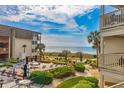 Exterior shot of the pool area, including lounge chairs and view of the ocean at 5601 N Ocean Blvd. # A-206, Myrtle Beach, SC 29577