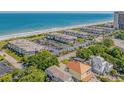 Coastal condominium complex near the beach with mature trees and lush landscaping at 5601 N Ocean Blvd. # E-304, Myrtle Beach, SC 29577