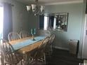 A six-chair dining table and a large mirror make the dining room bright and inviting at 5905 S Kings Hwy. # 314-B, Myrtle Beach, SC 29575
