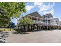 Charming elevated beach house with a spacious porch, offering stunning views and coastal living at its finest at 6001-1872 S Kings Hwy., Myrtle Beach, SC 29575