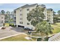 Condominium featuring a parking garage, lush landscaping, and charming design at 601 Hillside Dr. N # 1405, North Myrtle Beach, SC 29582