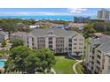 Aerial view of a charming condo building with balconies, set amongst lush greenery and the ocean at 601 Hillside Dr. N # 1405, North Myrtle Beach, SC 29582