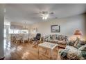 Open concept living room and dining area, with hardwood floors and ceiling fan at 615 2Nd Ave. S # 25B, North Myrtle Beach, SC 29582