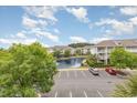 Scenic condo view with a pond, fountain, ample parking, and mature palm tree landscaping at 6253 Catalina Dr. # 131, North Myrtle Beach, SC 29582