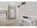 Welcoming entryway with neutral tones, a white console table, and decor hooks showcasing a neat arrival space at 6253 Catalina Dr. # 534, North Myrtle Beach, SC 29582