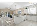 Bright kitchen with granite countertops, white cabinets, and tile flooring seamlessly connecting to the cozy living area at 6253 Catalina Dr. # 534, North Myrtle Beach, SC 29582