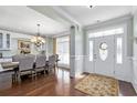 Elegant dining room features hardwood floors, wainscoting, and large windows, perfect for entertaining guests at 63 Grey Moss Rd., Murrells Inlet, SC 29576
