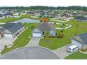 Aerial view of a well-manicured single-Gathering home and community with a pond at 713 Garland Ct., Myrtle Beach, SC 29588