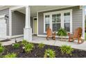Inviting front porch with rocking chairs, lush plants, and charming details at 812 Gammon Dr., Myrtle Beach, SC 29579