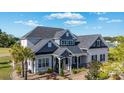 Beautiful home featuring a well-manicured lawn, lovely landscaping, and a welcoming front porch at 1017 Gallinule Dr., Conway, SC 29526
