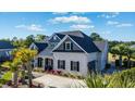 Beautiful home featuring a well-manicured lawn, lovely landscaping, and a welcoming front porch at 1017 Gallinule Dr., Conway, SC 29526