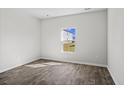 Bright bedroom with sleek, wood-look flooring, fresh paint, and a window offering outdoor views at 1031 Sentinel Ct., Little River, SC 29566