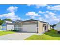 Inviting one-story home boasting a tidy lawn, neutral siding, a paved driveway, and an attached two-car garage at 1035 Sentinel Ct., Little River, SC 29566