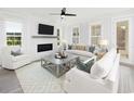 Bright living room featuring shiplap accent wall, fireplace, ceiling fan, and plenty of natural light at 1071 Milford Way, Myrtle Beach, SC 29588