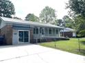 Charming home with a covered front porch, brick accents, and well-maintained landscaping at 1110 Scott Dr., Myrtle Beach, SC 29577