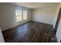 Bedroom with two windows and dark hardwood floors at 116 Forman Way, Aynor, SC 29511