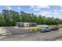 A charming single-story home with driveway and wooded backdrop on a sunny day at 116 Forman Way, Aynor, SC 29511