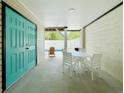 Covered patio area offers space for dining and relaxation, complete with a convenient entrance door at 118A 6Th Ave. N, Surfside Beach, SC 29575