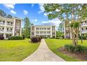 Building 21 with manicured front lawn in between other similar buildings at 1204 River Oak Dr. # 25-A, Myrtle Beach, SC 29579