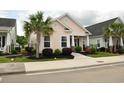 Inviting home exterior with a well-kept lawn, featuring a palm tree and a quaint front porch at 1308 Riverport Dr., Conway, SC 29526