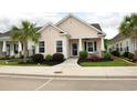 A beautiful single-story house with manicured lawn, palm tree, and walkway to the front porch at 1308 Riverport Dr., Conway, SC 29526