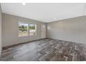 Inviting living room featuring wood-look flooring, a window, and a front door to the house at 1310 Rabbit Ln., Conway, SC 29526