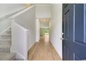 Inviting entryway with wood-look flooring and staircase at 162 Waterloo Sunset Dr., Longs, SC 29568