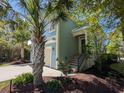 Inviting two-story home with lush landscaping and a front entrance accessible by stairs, offering curb appeal at 18 Trigger Fish Ln., Murrells Inlet, SC 29576