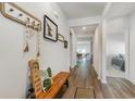 Hallway with wood flooring, decorative bench, and views to the dining room and bedroom at 1804 Castlebay Dr., Conway, SC 29526