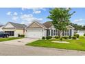 Street view of a cozy home with landscaped front yard, showcasing its curb appeal at 195 Cupola Dr., Longs, SC 29568