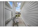 Exterior walkway showcasing a narrow space between two homes and a bench at 195 Cupola Dr., Longs, SC 29568