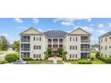 Attractive condo building featuring covered balconies and manicured landscaping at 2090 Cross Gate Blvd. # 202, Surfside Beach, SC 29575