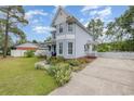 Two-story home with a covered porch and detailed landscaping in a well-maintained yard at 221 Lander Dr., Conway, SC 29526