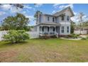 Attractive two-story home featuring a charming covered porch and white picket fence at 221 Lander Dr., Conway, SC 29526