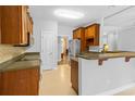 Functional kitchen featuring tiled floors and backsplash, stainless steel appliances, and adjacent pass through to the living area at 246 Laurel Bay Dr., Murrells Inlet, SC 29576