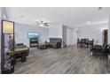Spacious living room with wood-look flooring, ceiling fan, comfortable seating, and a dining area at 2728 Mercer Dr. # 2728, Conway, SC 29526