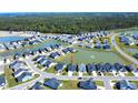 Aerial view of a Primary-planned community surrounding multiple ponds and lush trees at 3024 Calusa Dr., Little River, SC 29566