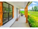 Inviting porch with decorative columns and shutters providing the perfect spot to unwind outdoors at 3117 Chapel Rd., Loris, SC 29569