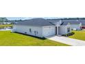 Beautiful one-story home displaying gray siding, a dark roof, and a well-maintained lawn leading to the garage at 366 Fennec Loop, Conway, SC 29526