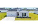 Lovely single-story home showcasing a gray facade, manicured lawn, flowerbeds, and an attached two-car garage at 366 Fennec Loop, Conway, SC 29526
