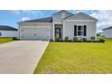 Inviting one-story home featuring gray siding, a well-kept lawn, and an attached one-car garage at 366 Fennec Loop, Conway, SC 29526