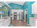 Open kitchen boasting stainless steel appliances, white cabinets, with breakfast bar and access to laundry room at 3907 Club Course Dr., North Myrtle Beach, SC 29582