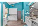 Bright kitchen featuring modern white cabinets, marble countertops, stainless steel appliances and blue accent walls at 3907 Club Course Dr., North Myrtle Beach, SC 29582
